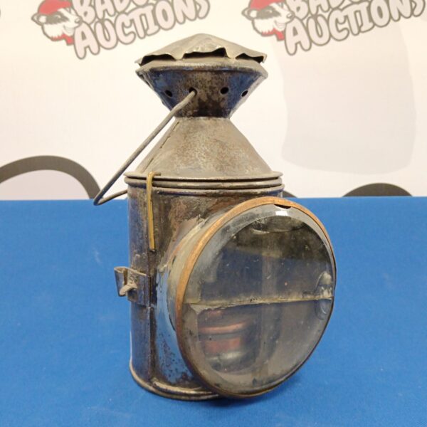 Antique Barton's miners lamp with glass enclosure and safety cage.
