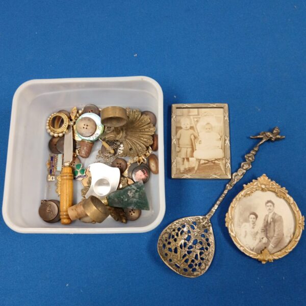 Overview of a mixed curios lot with vintage frames and badges.