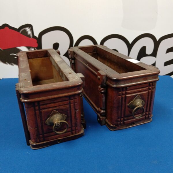 Antique mahogany under desk drawers with decorative knobs.