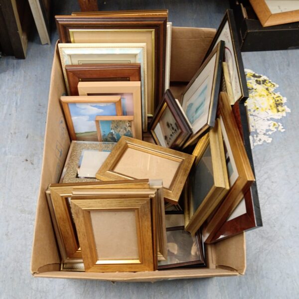 Lot of assorted vintage photo frames for display.