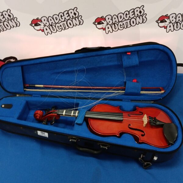 Stentor student violin inside its open case, showing bow and accessories.