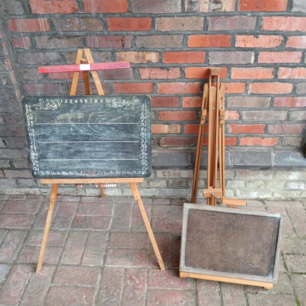 Vintage artist easels and chalkboards set for studio or classroom use.