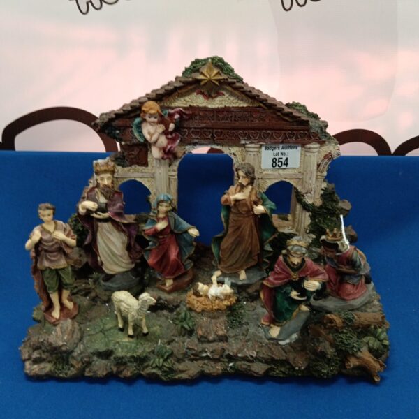 Detailed resin nativity scene ornament for Christmas decoration.