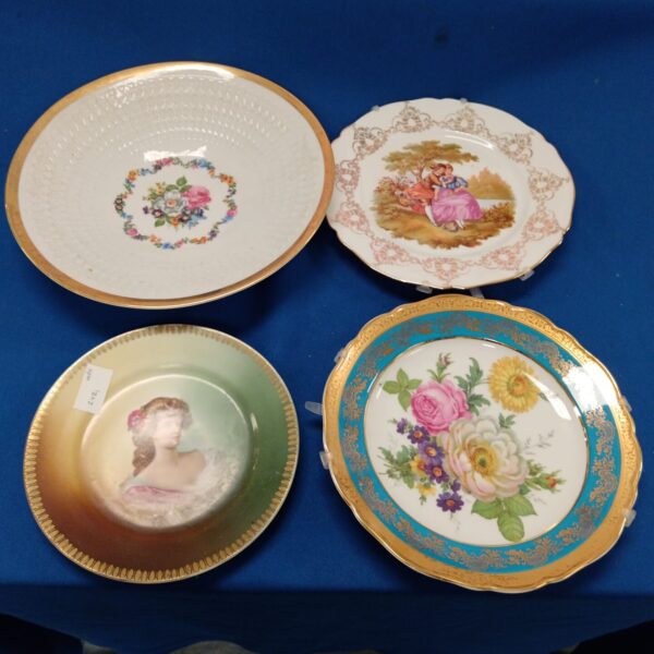 Vintage Limoges collectors plate with floral design and gilded edge.