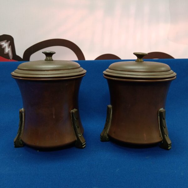 Vintage copper lidded pots with Art Deco styling.