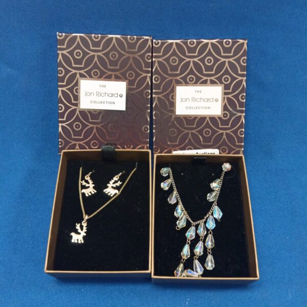 Jon Richard jewellery set with reindeer necklace and crystal necklace.