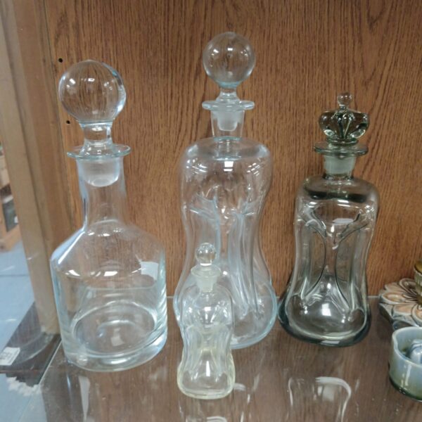 Lot of four vintage glass decanters for wine or spirits.