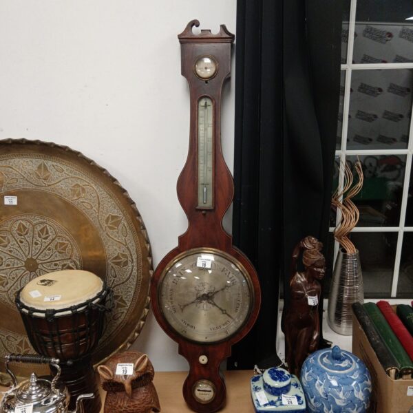 Antique mercury barometer with wooden case and detailed dial.