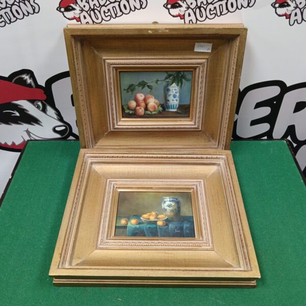 Vintage still life oil painting with floral arrangement in gilt frame.