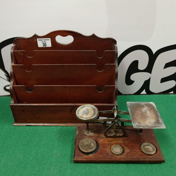 Vintage letter scales and wooden rack for correspondence.