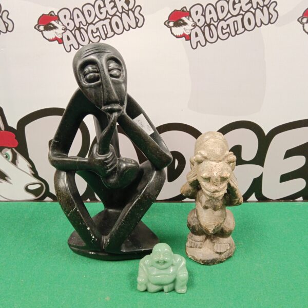 Detailed carved stone Buddha statue, part of a three-piece collection.