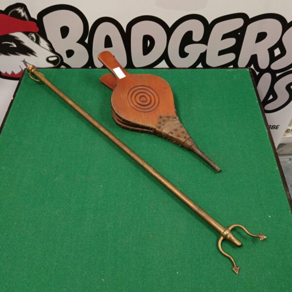 Vintage fireplace bellows with wooden handle and brass nozzle.
