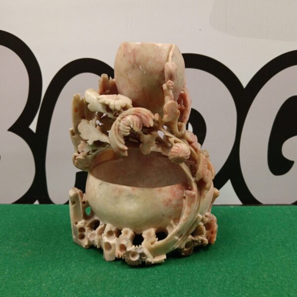 Intricate floral carving on a vintage Chinese soapstone pot.