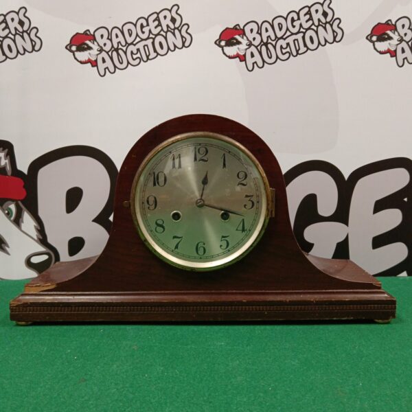 Vintage Napoleon hat mantle clock on display.