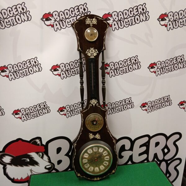 Vintage barometer clock with wooden case and Roman numerals.