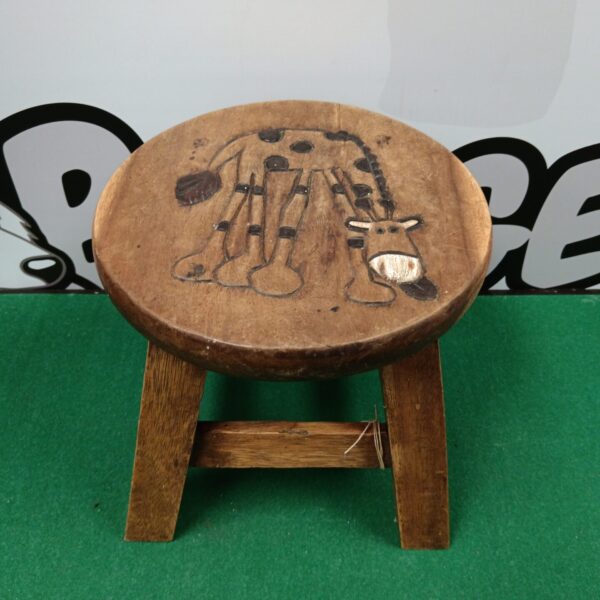 Vintage wooden child's stool with giraffe carving.