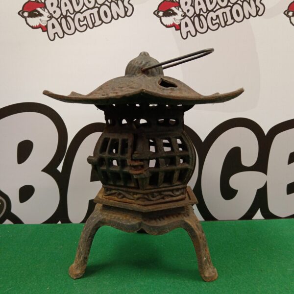 Antique cast iron Chinese candle lantern with pagoda design.