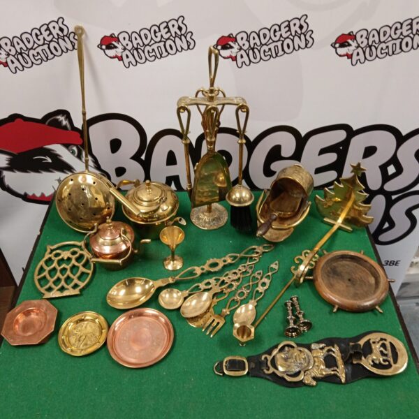 Vintage brass and copper lot with decorative plates and bell.