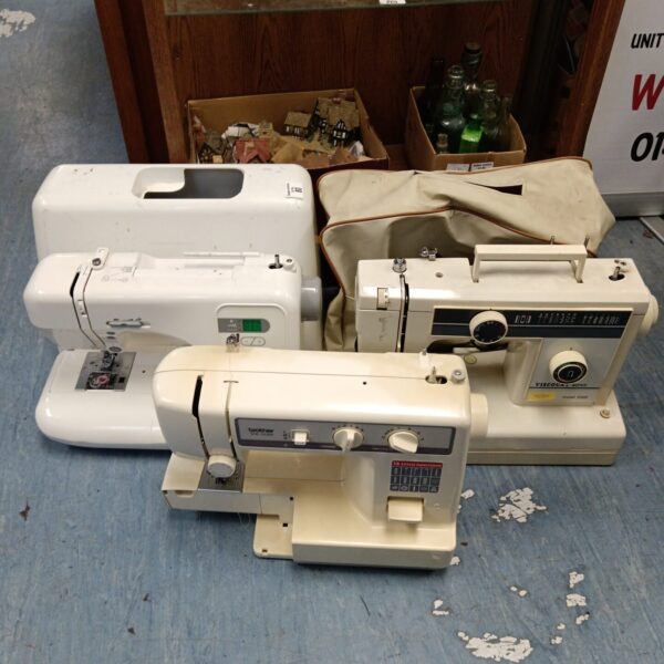 Vintage lot of three electric sewing machines, including a Brother.