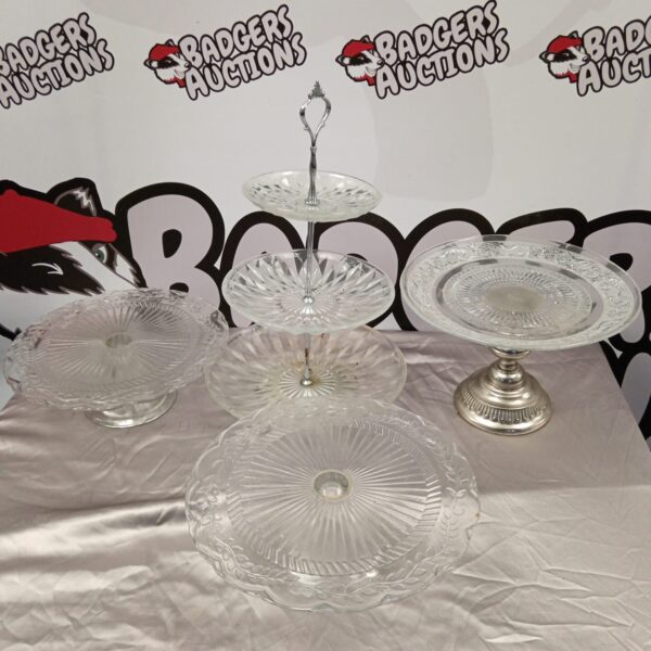 Four vintage glass cake stands on display.