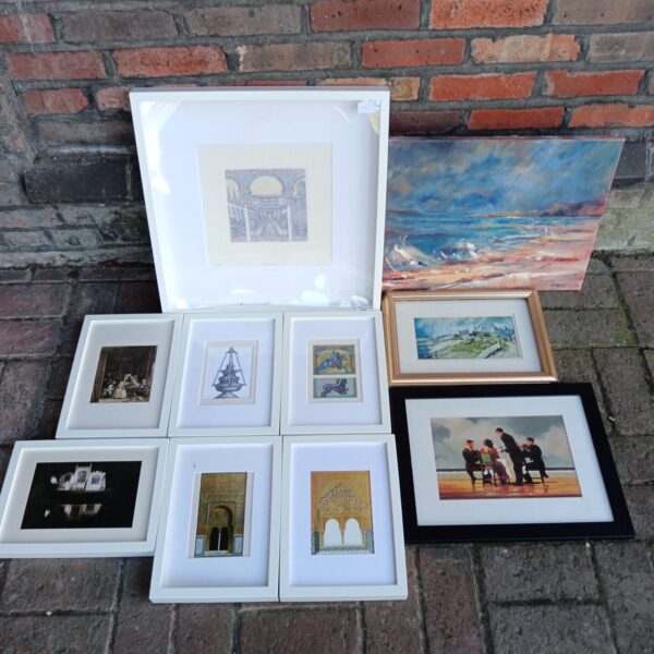 Framed art collection featuring diverse prints and artwork.