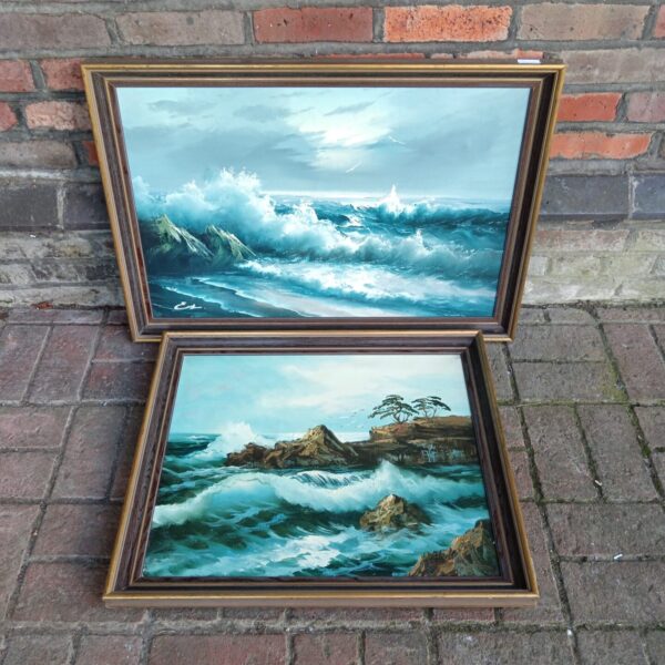 Pair of vintage oil seascape paintings depicting rough seas.