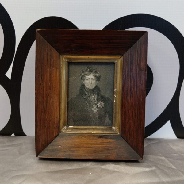 Antique miniature portrait of King George IV in dark wood frame.