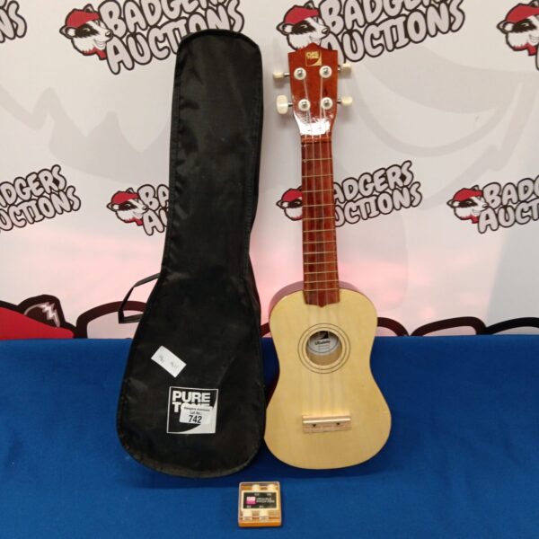 Vintage ukulele with black case, acoustic string instrument.