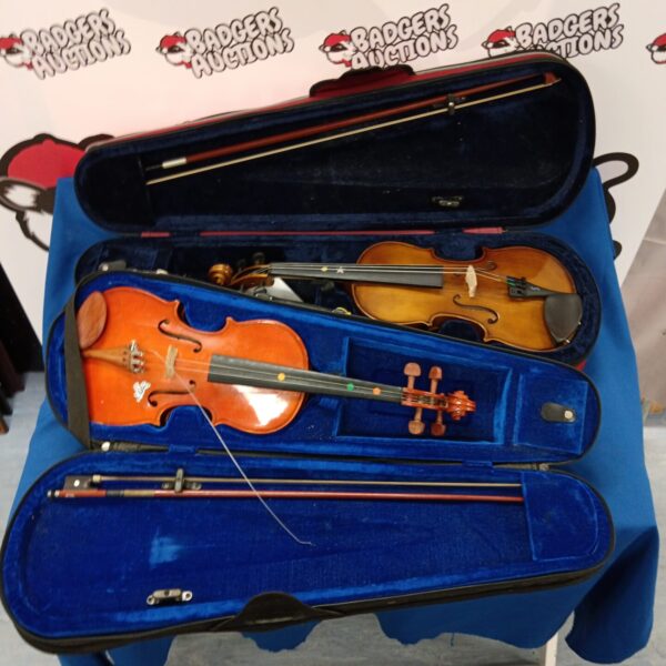 Two Stentor violins inside their protective cases, musical instruments.