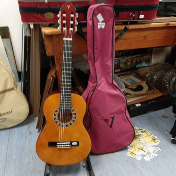 Vintage Valencia child's acoustic guitar with pink case.