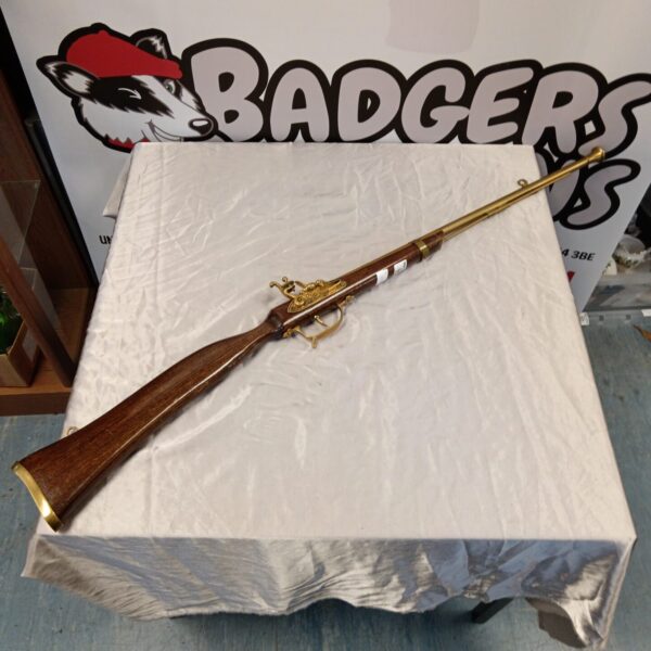Antique flintlock musket for wall display, decorative historical firearm.