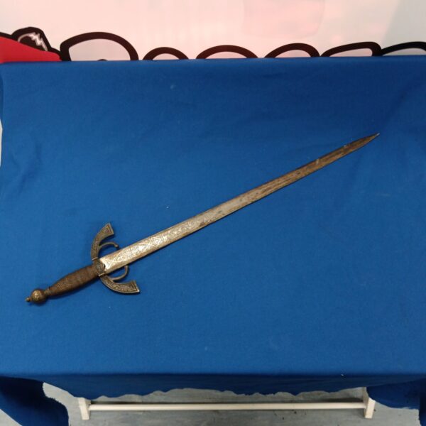 Antique Spanish ceremonial sword with detailed hilt and curved blade.
