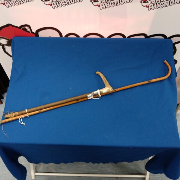 Vintage walking cane with silver cuff and horn handle.