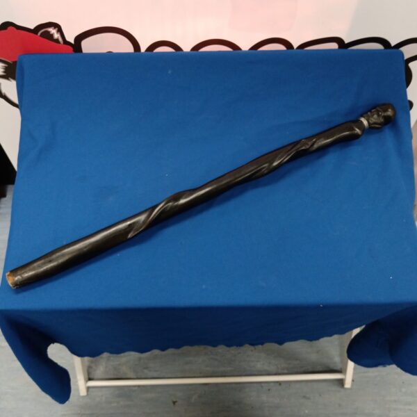 Carved African walking cane made of dark hardwood.
