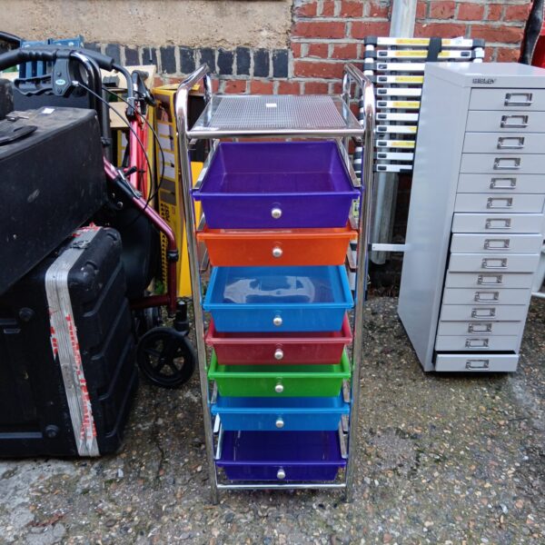 Brightly coloured plastic craft drawers on a rolling cart.