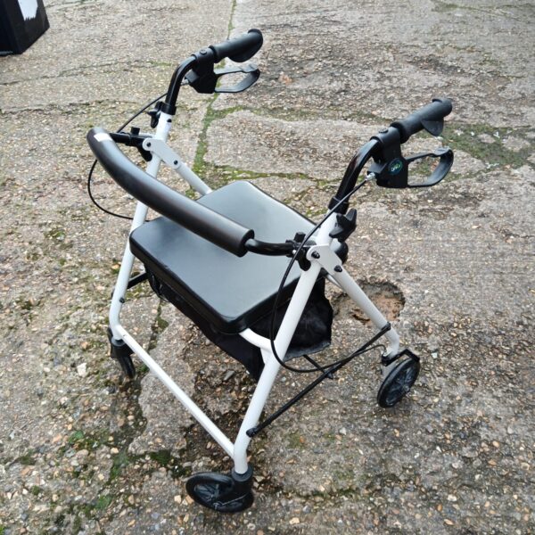 Care Co mobility walker with padded seat and wire basket.