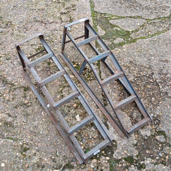 Pair of metal car ramps for vehicle maintenance and repair.