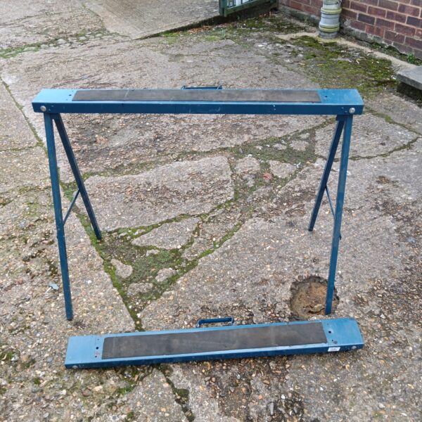 Pair of metal folding tressles for workshop or DIY use.
