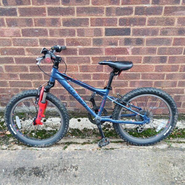 Blue Carrera child's bike with front suspension and knobbly tyres.