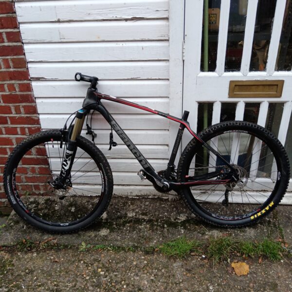 Black and red Bianchi carbon mountain bike for off-road cycling.