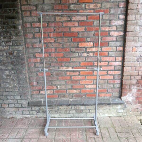 Mobile two-tier clothes rail for garment storage.