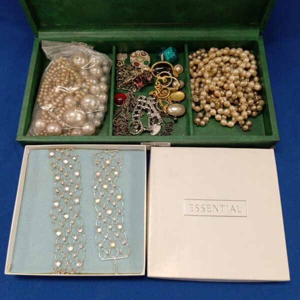 Vintage costume jewellery tray with faux pearl necklaces and fashion pieces.