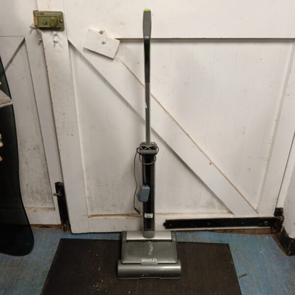 Gtech Air Ram vacuum cleaner on a floor, cordless and lightweight.