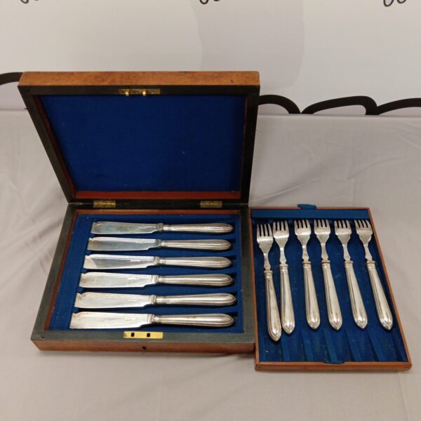 Vintage silver plate fish knife and fork set in a wooden case.