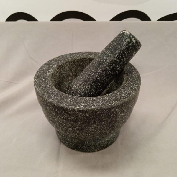 Grey granite pestle and mortar for grinding spices and herbs.