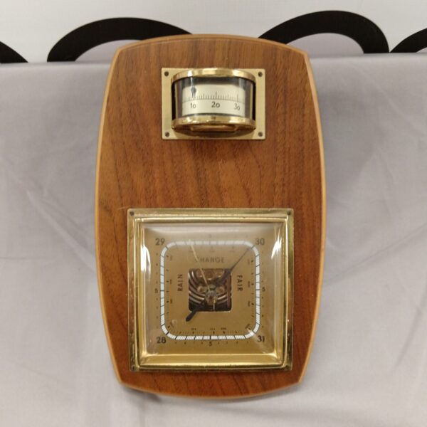 Vintage German barometer with wooden frame and circular dial.