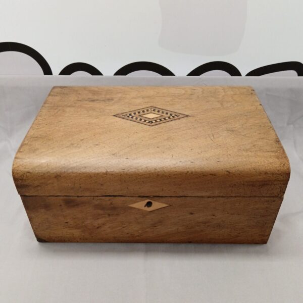 Vintage wooden stationery box with inlaid detail on the lid.