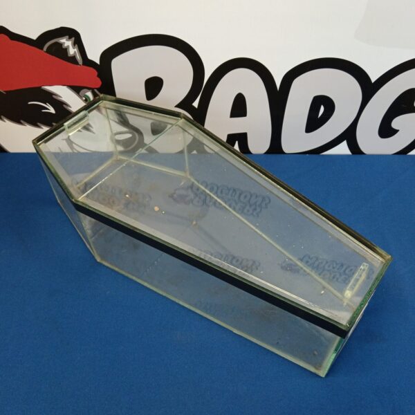 Vintage glass display case with a coffin shape for collectibles.