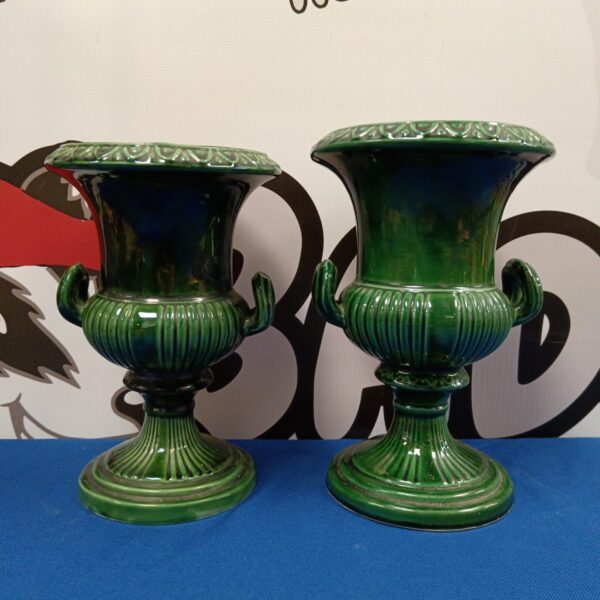 Pair of vintage green Dartmouth Pottery urns on display.