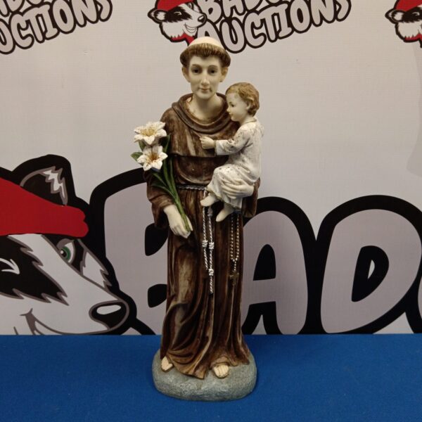 Detailed resin sculpture of a monk holding a child.